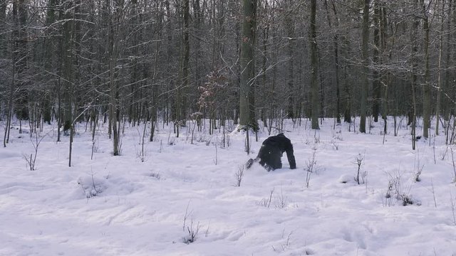 Man runs like crazy through the forest in the winter.