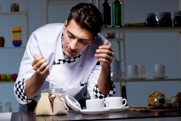 Coffee barista working late in shop preparing drinks