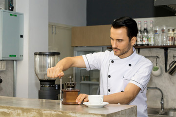 Barista is making coffee in a coffee shop.