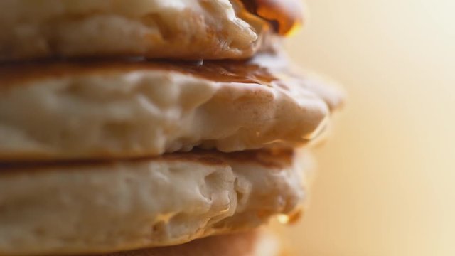 Pouring honey on stack of pancakes. Shot with high speed camera, phantom flex 4K. Slow Motion.