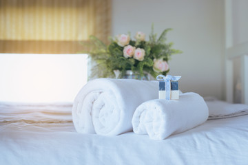 White towel on bed,Stack of plush hotel towels