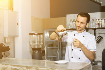 Barista is making coffee in a coffee shop.