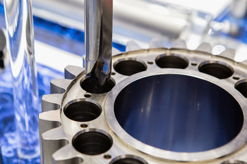 The CNC milling machine is drilling the sample gear part in modern manufacturing