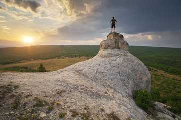 Man on peak of mountain.