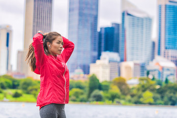 Running healthy lifestyle in urban runner Asian woman getting ready to run morning cardio exercise.