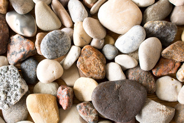 A lot of sea pebbles scattered around the table