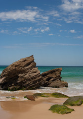 Fototapeta na wymiar Rocky outcrop at the beach on a sunny summer day
