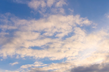 Spring blue sky with a few clouds . On a blue background