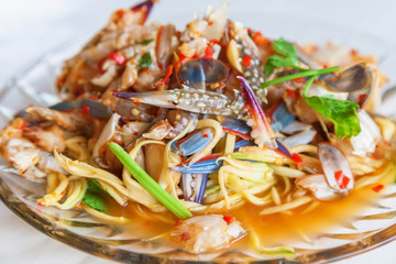 Papaya salad and fresh blue crab in dish , Thai food © omjai
