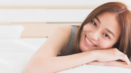 Obraz na płótnie Canvas Young Asian beautiful woman smiling and relax on bed in bedroom.Health and beauty woman concept.