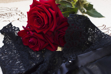 Red roses on a black lace lingerie