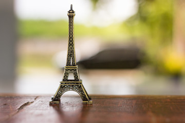 Eiffel model is placed on a wooden desk.