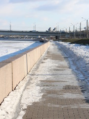 embankment in the snow and a frozen river