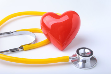 Red heart and a stethoscope on white background