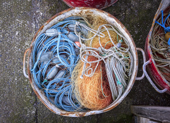 A bucket with different nets needed for fishing