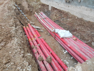 Underground utility and services pipe lay by workers at the construction site.  