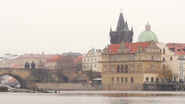 snow falling in slow m otion in Old town Prague from . River Vltava