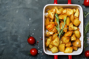 Baked potatoes with spices and rosemary, top view