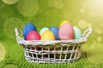 Fototapeta na wymiar Painted Easter eggs in a basket. Easter background. Spring religious holiday easter concept