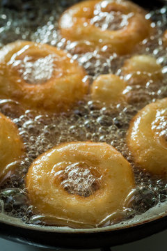 Frying homemade sweet donuts on hot oil