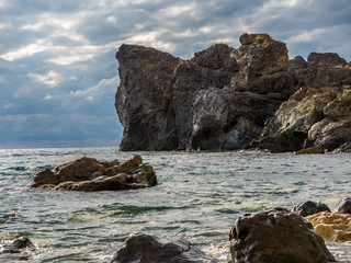 A sea shore with rocks and stones, weather is cloudy. Black sea, Crimea
