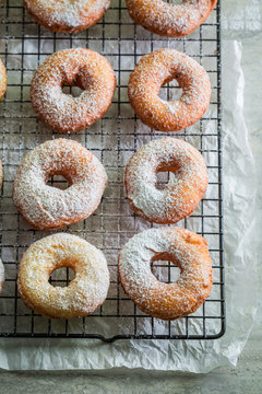 Delicious golden donuts freshly baked with powdered sugar