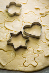 Cutting tasty milky biscuits from fresh dough