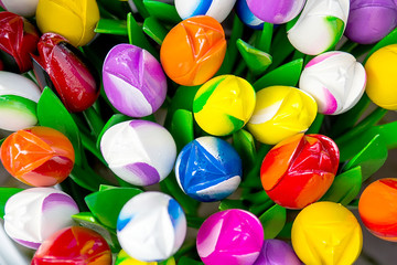 Colorful plastic decorative artificial tulips, close-up, background