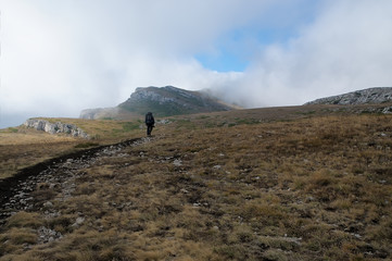 A tourist at the top Crimean Chatyr-Dag mountain in autumn