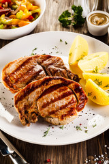 Grilled steak, boiled potatoes and vegetable salad 