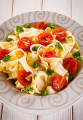 Pasta with vegetables on wooden table