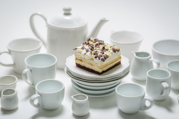 Delicious white cake with mousse, chocolate and porcelain