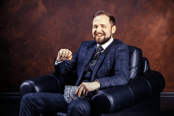 Businessman holding golden Bitcoin, Ticker Symbol BTC and dollar banknotes, finance money bitcoin concept.