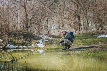 fisherman fishing by the water in the winter.
