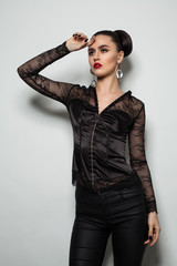 Fototapeta premium Fashion Portrait of Elegant Young Woman in Black Clothes
