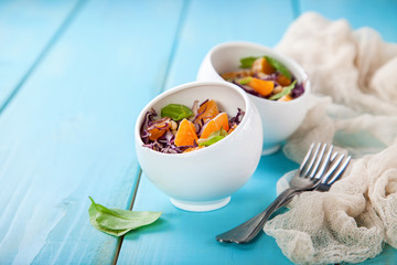 Red cabbage tangerines and pine nuts salad. Selective focus. Copy space.