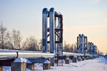 Overground heat pipes. Pipeline above ground, conducting heat for heating the city. Winter. Snow.