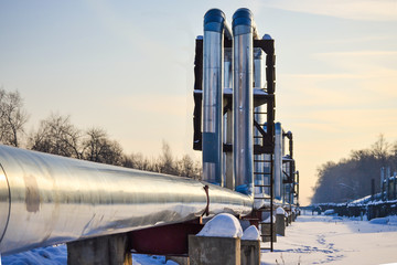 Overground heat pipes. Pipeline above ground, conducting heat for heating the city. Winter. Snow.