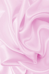 Smooth elegant pink silk or satin texture as wedding background. Luxurious background design