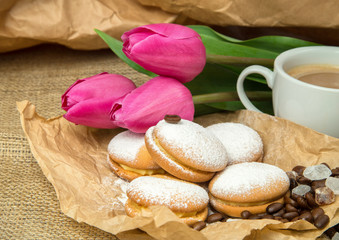 still life of coffee, biscuits, sugar on a rough background in brown tones