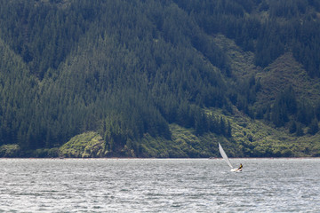 Obraz premium Young man on the sailing boat