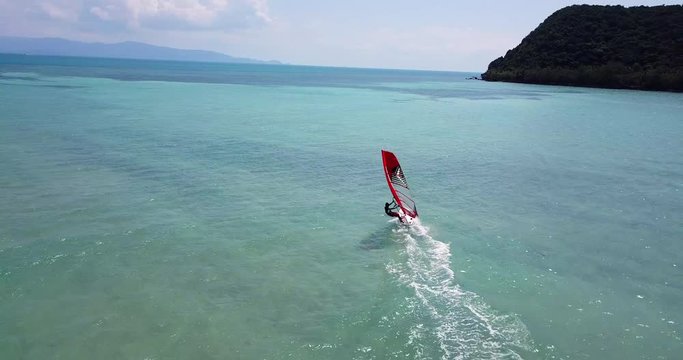 RomanchikAERIAL 4K: Wind surfing,surfer in the open sea on a windy day at a koh Phangan island,Thailand