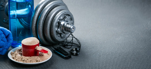Sport concept - gym supplies on yoga mat background