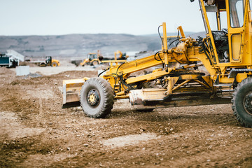 Obraz premium Industrial road construction site, highway building. Heavy duty machinery working on site