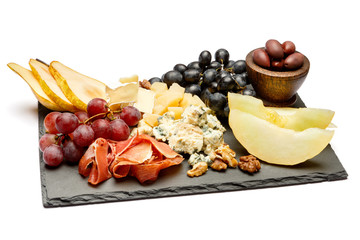Meat plate antipasti snack - Prosciutto ham, blue cheese, melon, grapes, Olives
