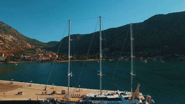 A large yacht stands at the pier in the bay Kotor, Montenegro. Aerial footage
