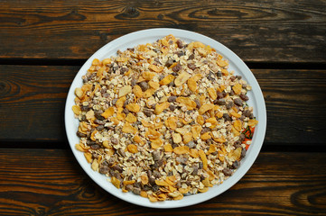 cereals in white dish on wooden floor