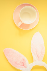 Easter holiday background with cup for coffee and bunny ears