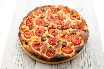 Focaccia typical of Bari Italy with tomatoes and olive