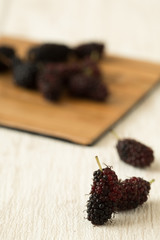 mulberry fruit fresh sour and sweet purple red on wood background